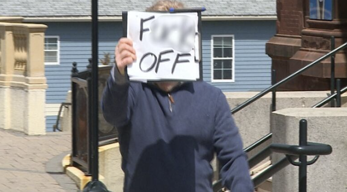 A man with a poster after a dog bite